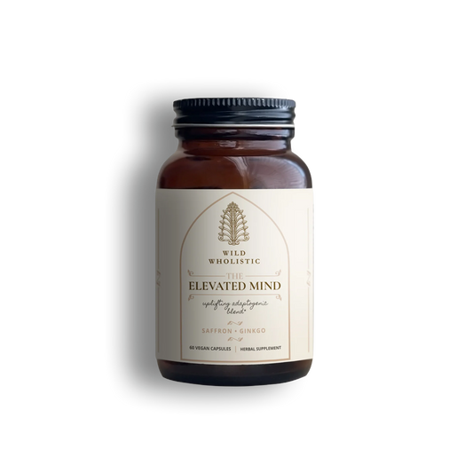 Supplement bottle 'Elevated Mind,' an uplifting adaptogenic blend by Wild Wholistic.